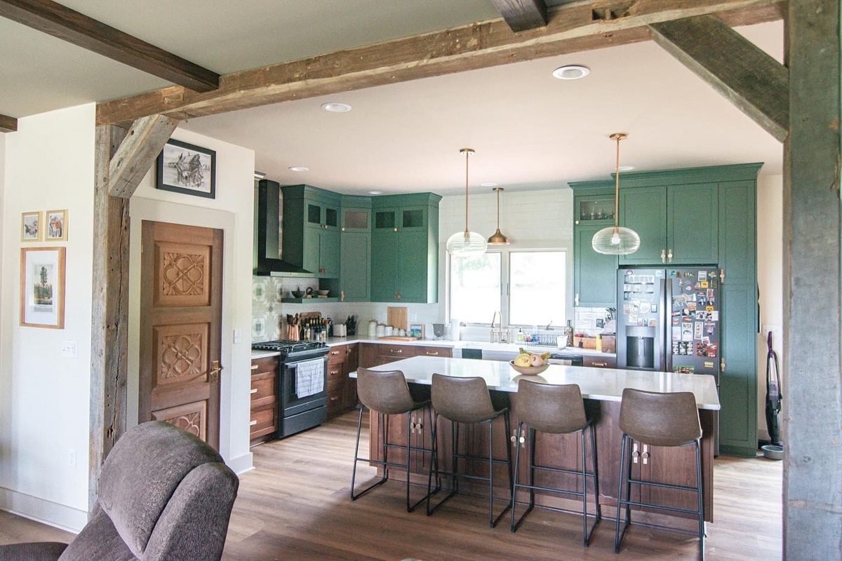 Green kitchen with wood beams